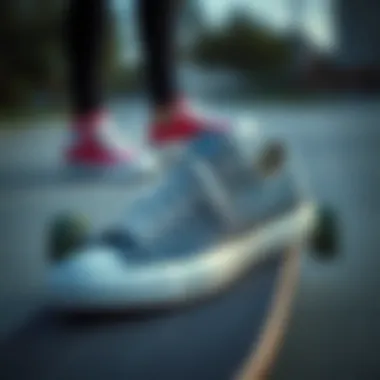 Grey Converse Sneakers and Skateboarding Culture A stylish pair of grey Converse sneakers resting on a skateboard