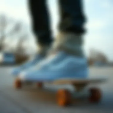 Light gray Vans high tops on a skateboard