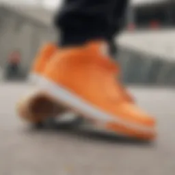 A close-up of Nike shoes showcasing vibrant orange accents against a skate park backdrop