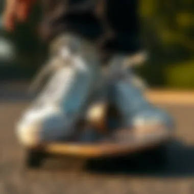 A pair of silver Converse shoes styled on a skateboard