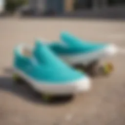 A vibrant pair of turquoise Vans slip-ons on a skateboard