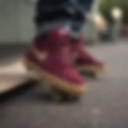 Close-up of maroon Nike skate shoes on a skateboard