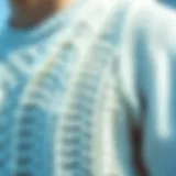 Close-up of a textured white sweater vest showcasing intricate knit patterns